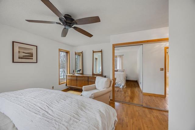 1171 County Rd E, Scott Twp, WI 54801 - bedroom with light wood-style floors, baseboards, a ceiling fan, and a closet