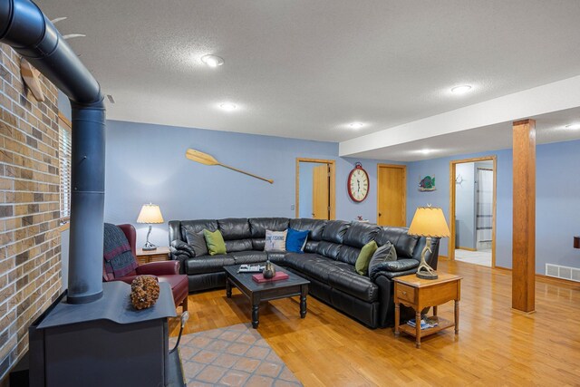 1171 County Rd E, Scott Twp, WI 54801 - living room with visible vents, a wood stove, recessed lighting, light wood-type flooring, and a textured ceiling