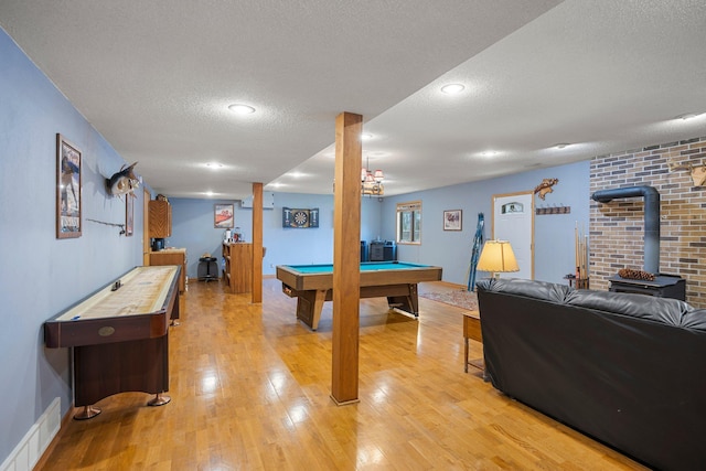 1171 County Rd E, Scott Twp, WI 54801 - rec room featuring a wood stove, light wood-style floors, a textured ceiling, pool table, and visible vents
