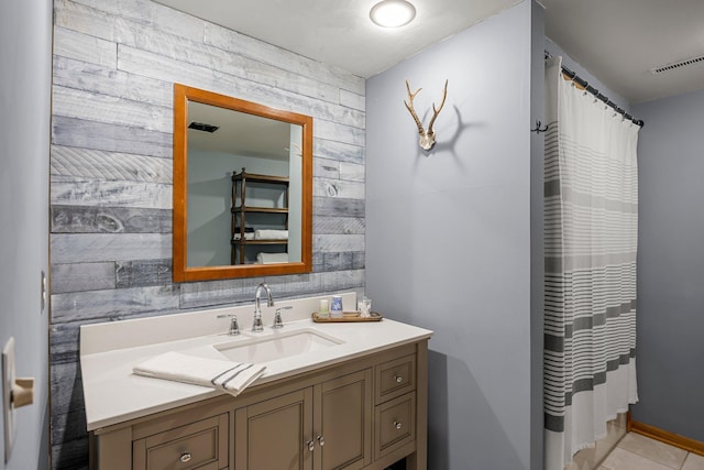 1171 County Rd E, Scott Twp, WI 54801 - full bath featuring vanity, tile patterned flooring, visible vents, an accent wall, and wooden walls