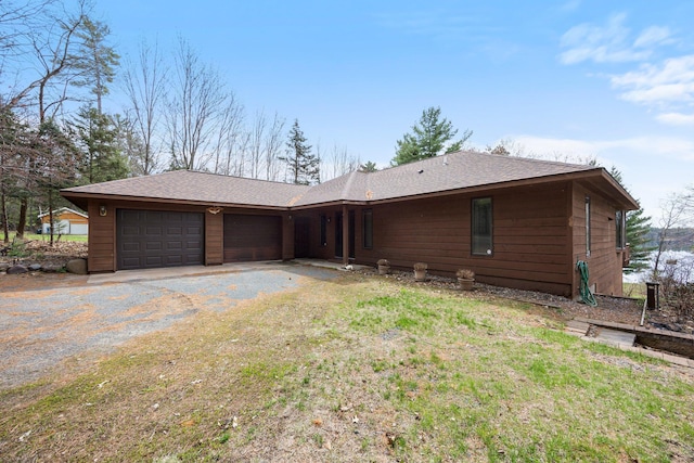 1171 County Rd E, Scott Twp, WI 54801 - view of front facade with a garage, a shingled roof, and gravel driveway