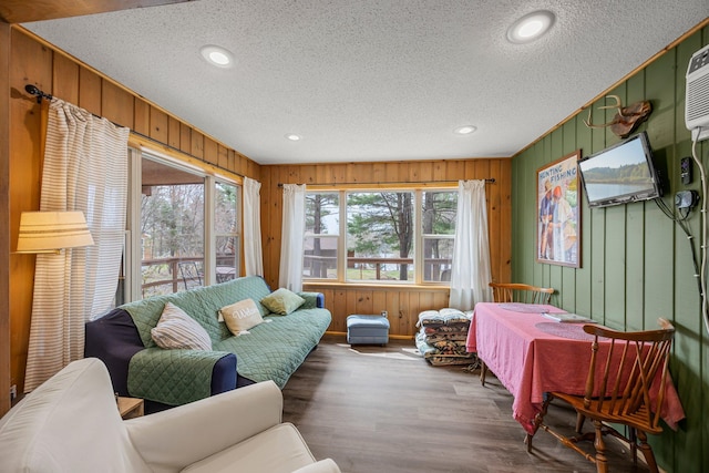 1171 County Rd E, Scott Twp, WI 54801 - living area featuring a textured ceiling, wood finished floors, and wooden walls