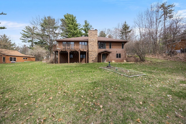 1171 County Rd E, Scott Twp, WI 54801 - rear view of house featuring a lawn, a wooden deck, and a chimney
