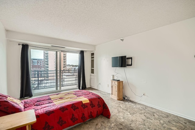 bedroom featuring a textured ceiling, visible vents, and baseboards