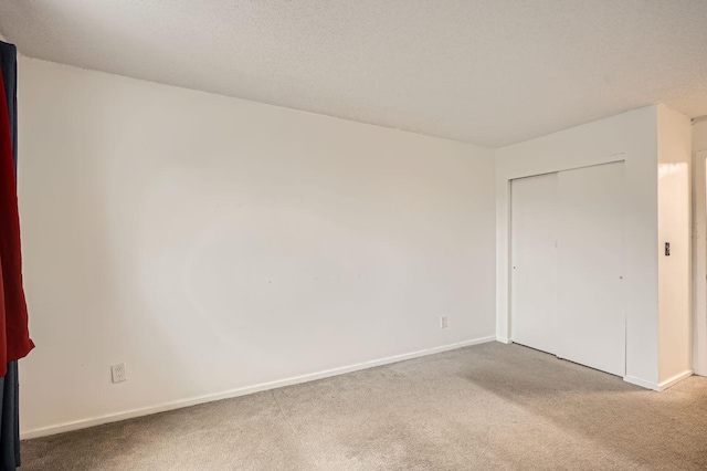 spare room with carpet floors and baseboards
