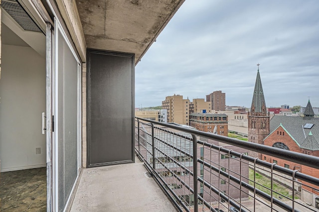 balcony with visible vents and a city view