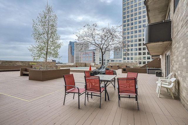 wooden terrace with outdoor dining space