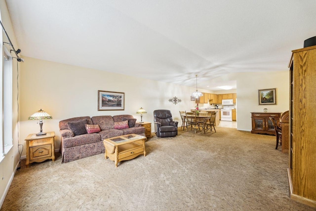 living area featuring light carpet and baseboards