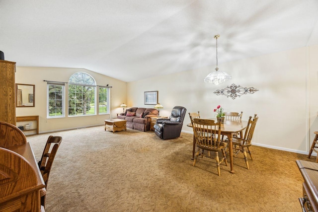 dining space with lofted ceiling, carpet floors, a chandelier, and baseboards