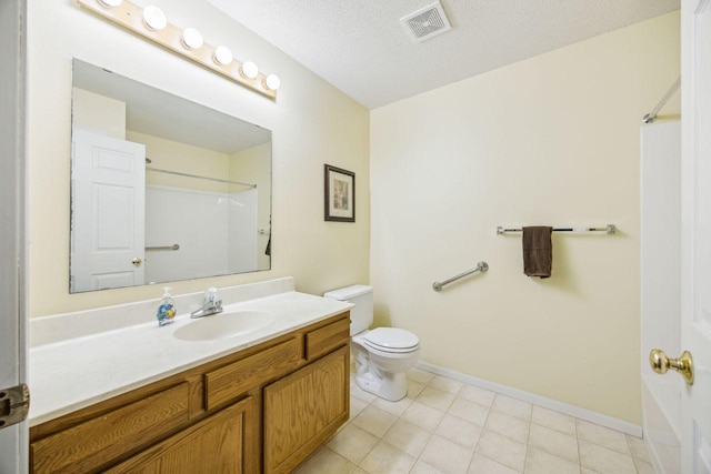 bathroom with toilet, a shower, vanity, baseboards, and a textured ceiling