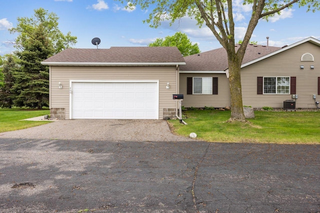 ranch-style home featuring central AC unit, driveway, an attached garage, a front lawn, and a shingled roof