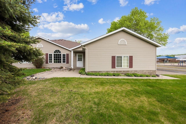 rear view of house featuring a yard