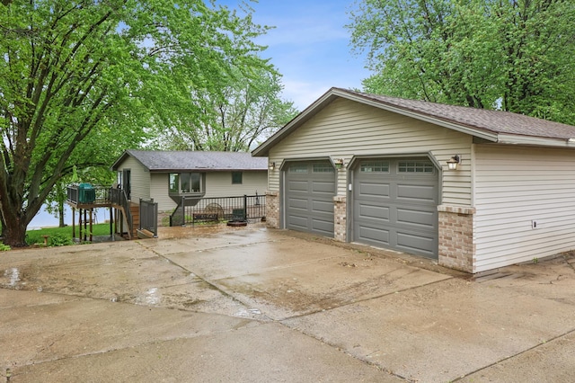 2060 Donnelly Dr NW, Maple Lake Twp, MN 55313 - view of front of house with an outbuilding, brick siding, a detached garage, and a shingled roof