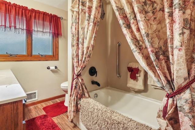 2060 Donnelly Dr NW, Maple Lake Twp, MN 55313 - bathroom featuring vanity, toilet, shower / bath combination with curtain, wood finished floors, and baseboards