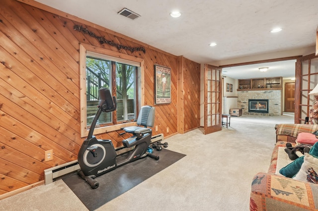 2060 Donnelly Dr NW, Maple Lake Twp, MN 55313 - workout area featuring a fireplace, wooden walls, a baseboard radiator, carpet flooring, and recessed lighting