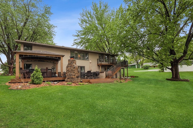 2060 Donnelly Dr NW, Maple Lake Twp, MN 55313 - back of house with a deck, an attached garage, a lawn, and stairs
