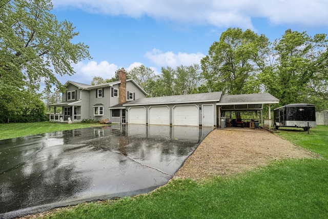 18701 Delton Ave, Minnetonka, MN 55345 - view of front of home with driveway, a chimney, a front lawn, and an attached garage