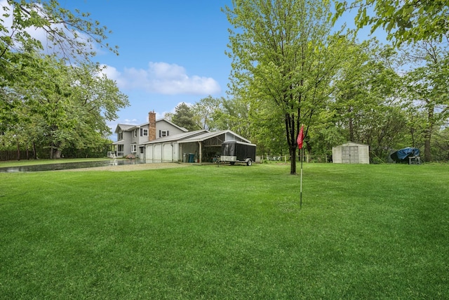 18701 Delton Ave, Minnetonka, MN 55345 - view of green lawn with an outbuilding and a storage shed