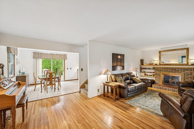 18701 Delton Ave, Minnetonka, MN 55345 - living room with light wood-type flooring, a fireplace, baseboards, and stairway