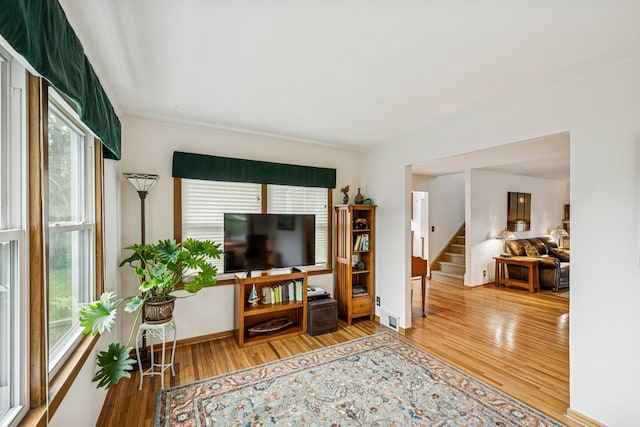 18701 Delton Ave, Minnetonka, MN 55345 - living area featuring healthy amount of natural light, wood finished floors, stairway, crown molding, and baseboards