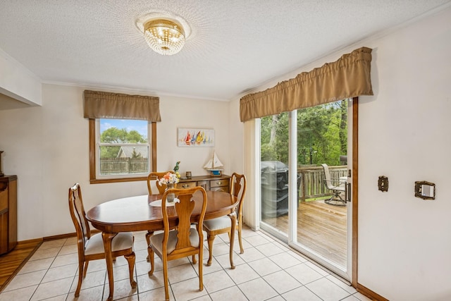 18701 Delton Ave, Minnetonka, MN 55345 - dining area with plenty of natural light, a textured ceiling, crown molding, light tile patterned flooring, and a chandelier