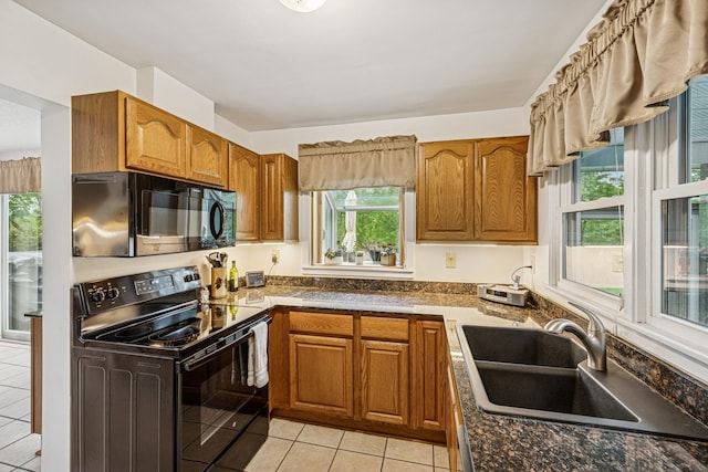 18701 Delton Ave, Minnetonka, MN 55345 - kitchen with black appliances, light tile patterned floors, brown cabinets, and a sink