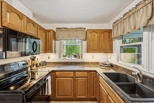 18701 Delton Ave, Minnetonka, MN 55345 - kitchen featuring black appliances, a sink, plenty of natural light, and brown cabinetry