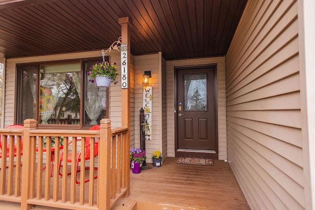 view of exterior entry featuring covered porch