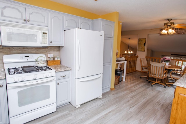 kitchen with ceiling fan with notable chandelier, white cabinets, light wood-style floors, and white appliances