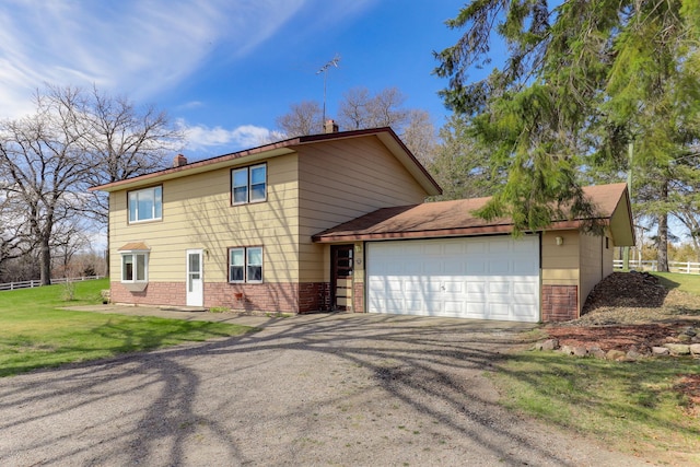 view of front of house featuring a garage, brick siding, a front lawn, and driveway