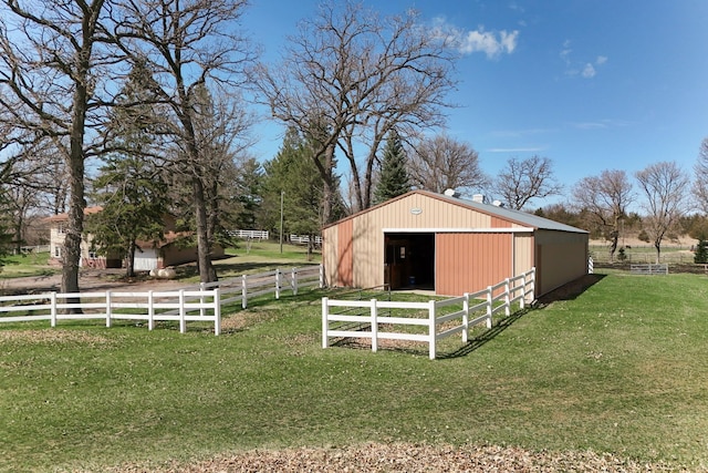view of pole building with a yard and fence