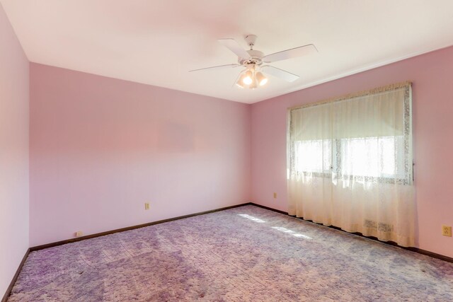 unfurnished room featuring baseboards, ceiling fan, and carpet flooring