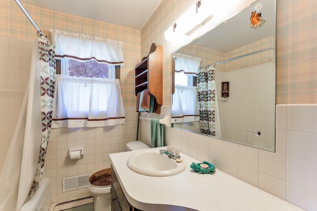 bathroom with tile walls, visible vents, a healthy amount of sunlight, and toilet
