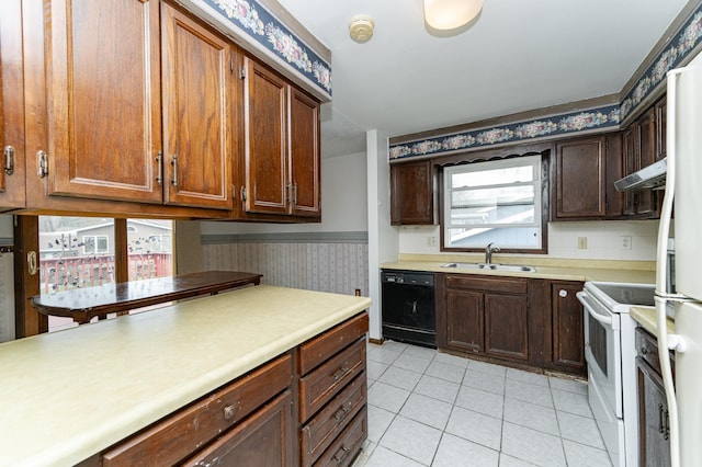 kitchen with white appliances, extractor fan, wallpapered walls, light countertops, and a sink
