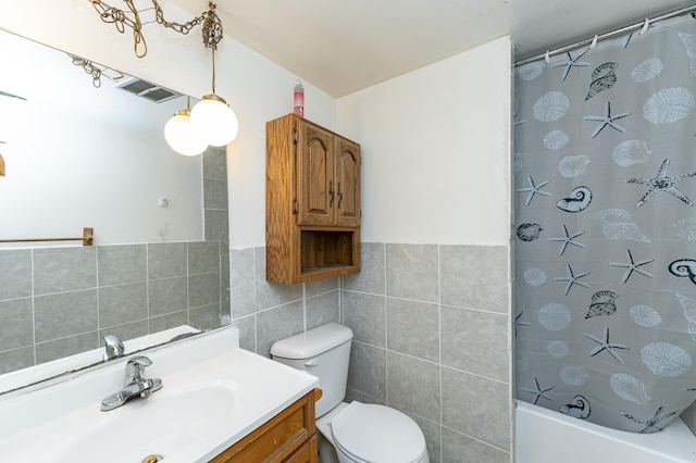 bathroom featuring shower / tub combo with curtain, vanity, toilet, tile walls, and visible vents