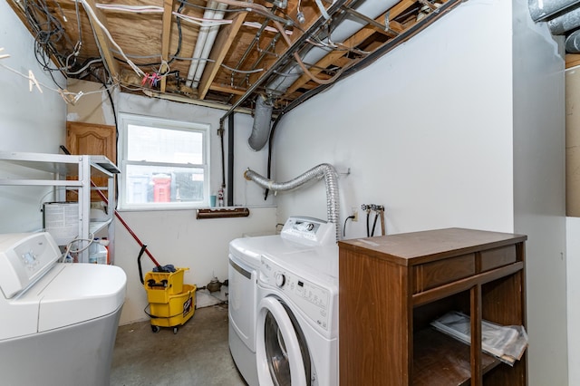 clothes washing area featuring laundry area and washer and clothes dryer
