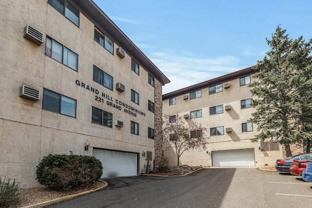 221 Grand Ave W Unit 111, South Saint Paul, MN 55075 - view of building exterior featuring a wall mounted AC
