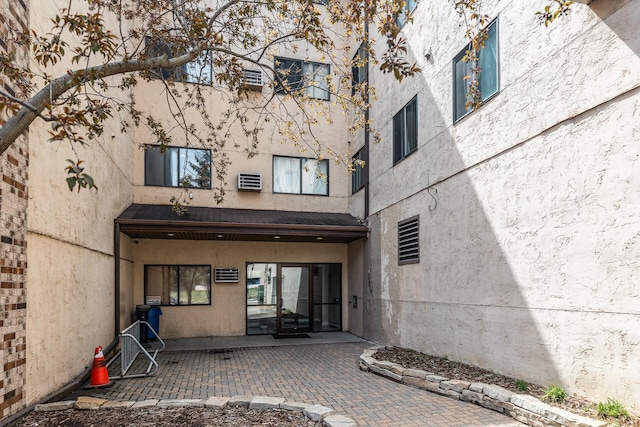 221 Grand Ave W Unit 111, South Saint Paul, MN 55075 - view of exterior entry featuring a patio and stucco siding