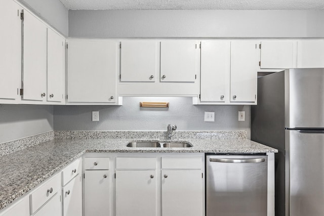 221 Grand Ave W Unit 111, South Saint Paul, MN 55075 - kitchen featuring a sink, stainless steel appliances, a textured ceiling, and white cabinets