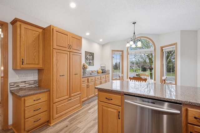 kitchen featuring light stone countertops, dishwasher, light wood finished floors, lofted ceiling, and recessed lighting