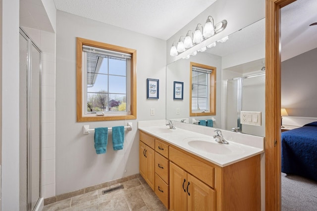 full bathroom with visible vents, a shower stall, a sink, and ensuite bath