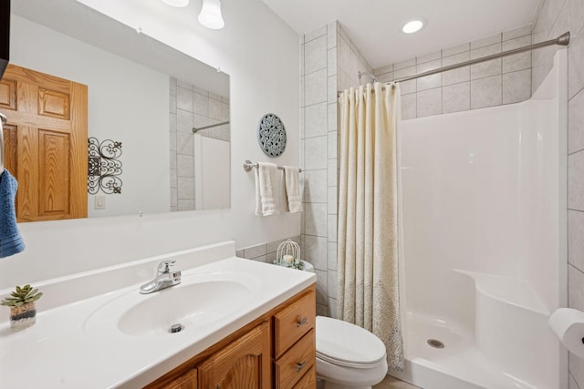 full bathroom with vanity, toilet, and a stall shower
