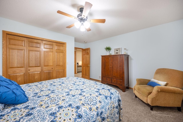 bedroom with ceiling fan, light colored carpet, baseboards, and a closet