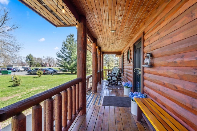 510 State Rd Unit 35, Centuria, WI 54024 - wooden deck with covered porch and a yard