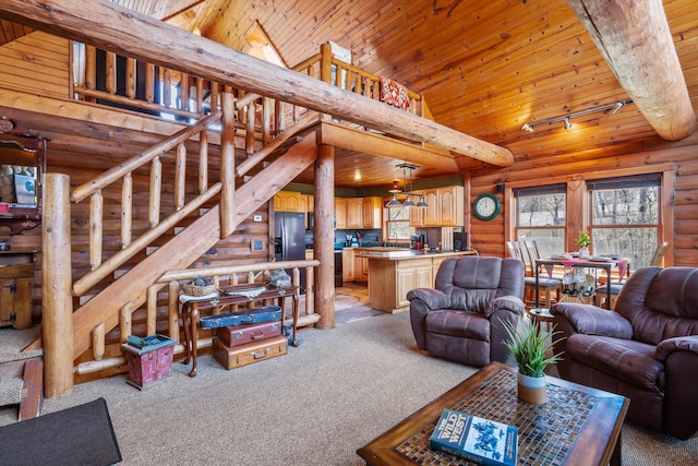 510 State Rd Unit 35, Centuria, WI 54024 - living room featuring light colored carpet, vaulted ceiling, track lighting, and stairway