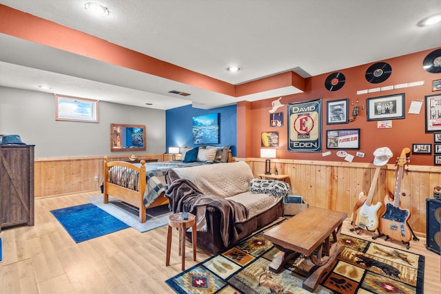 510 State Rd Unit 35, Centuria, WI 54024 - bedroom featuring visible vents, wainscoting, wood walls, wood finished floors, and recessed lighting