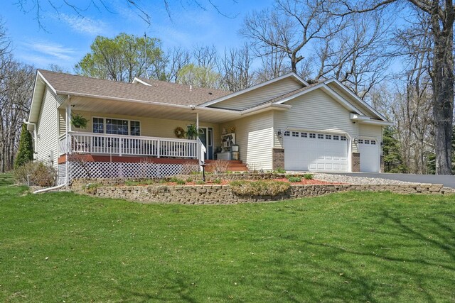 ranch-style house featuring covered porch, aphalt driveway, a front lawn, and a garage