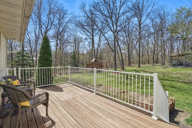 wooden deck featuring a lawn