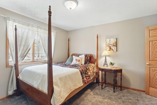 bedroom featuring baseboards, a textured ceiling, and carpet