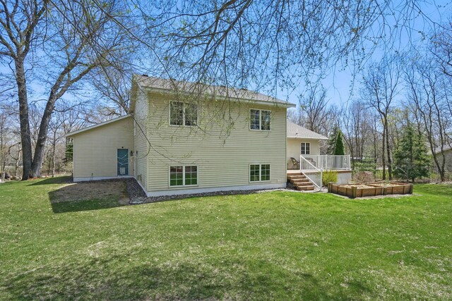back of property featuring a yard and a deck